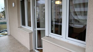 A corner of a building with large windows and a small window ledge. - Apartament F&J 12 (Torun)