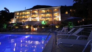 A hotel with a swimming pool, multiple balconies, and outdoor umbrellas. - Hotel Costa Rossa (Ota)