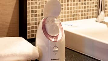 A Panasonic EH-SA3A electric kettle on a countertop with a tiled backsplash and a sink in the background.