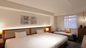 A hotel room with a large bed, a sofa, a desk, and a window with patterned curtains. - Hotel Forza Hakataeki Chikushi - Guchi II (Fukuoka)