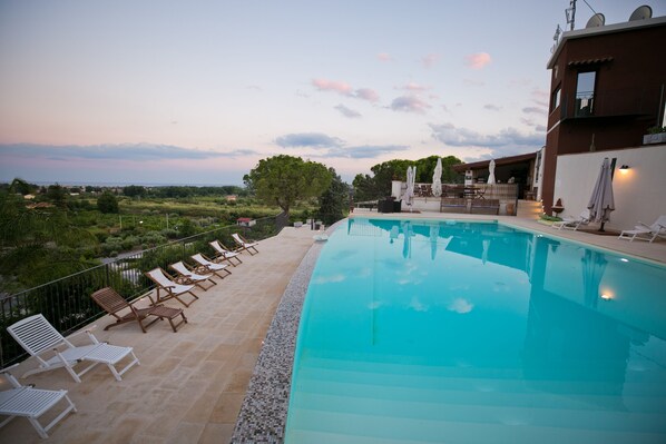 Seasonal outdoor pool, open 9:30 AM to 6:30 PM, pool umbrellas