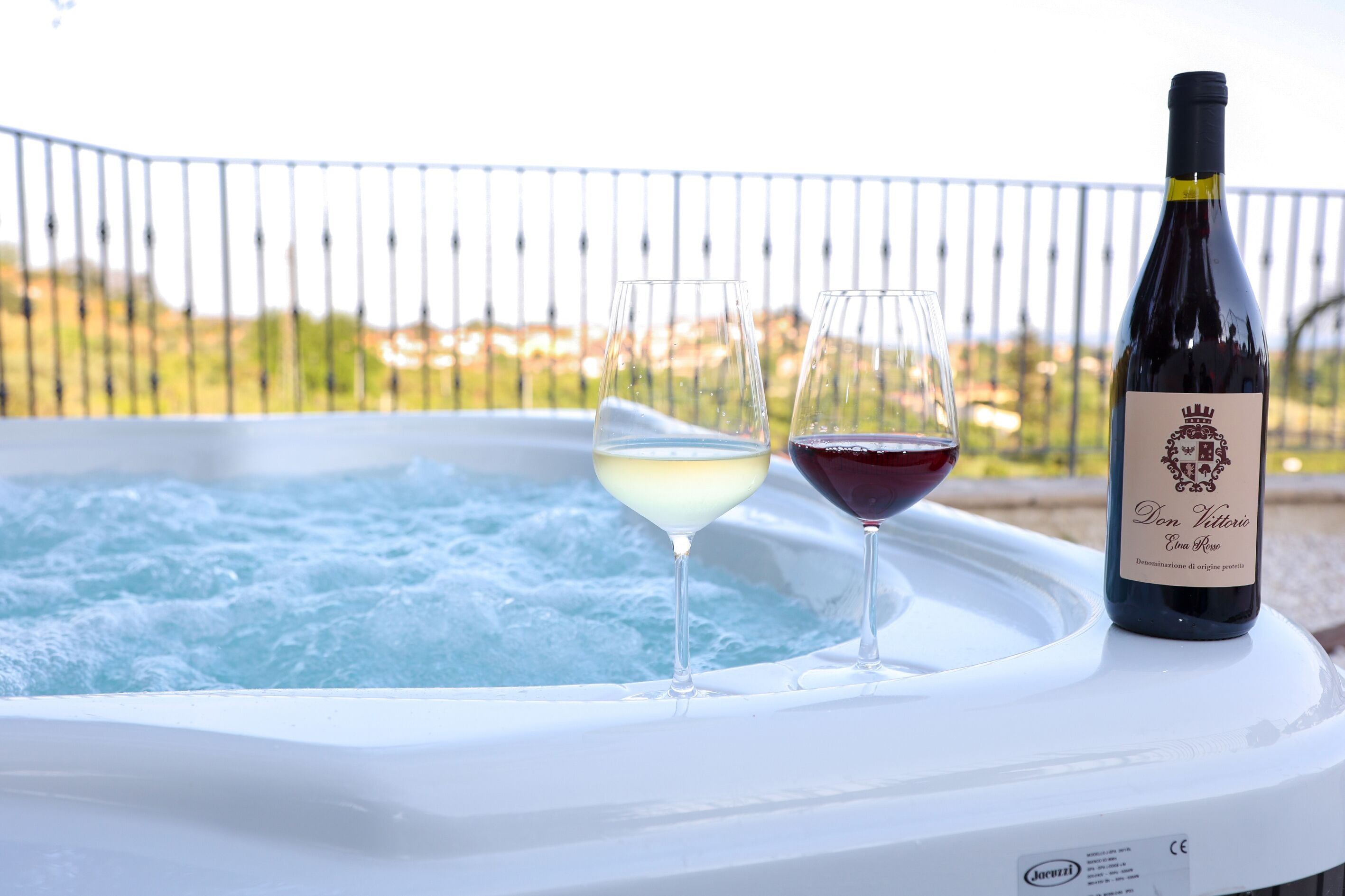 Un bain à remous avec deux verres de vin et une bouteille de vin.