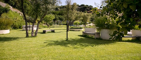 A well-maintained garden with seating areas and trees.