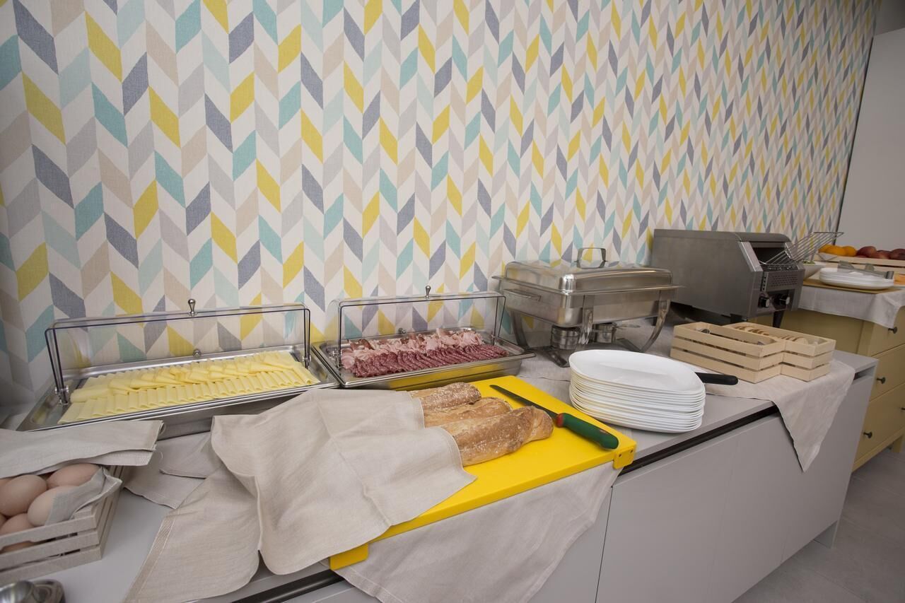 A buffet setup with various food items and utensils.