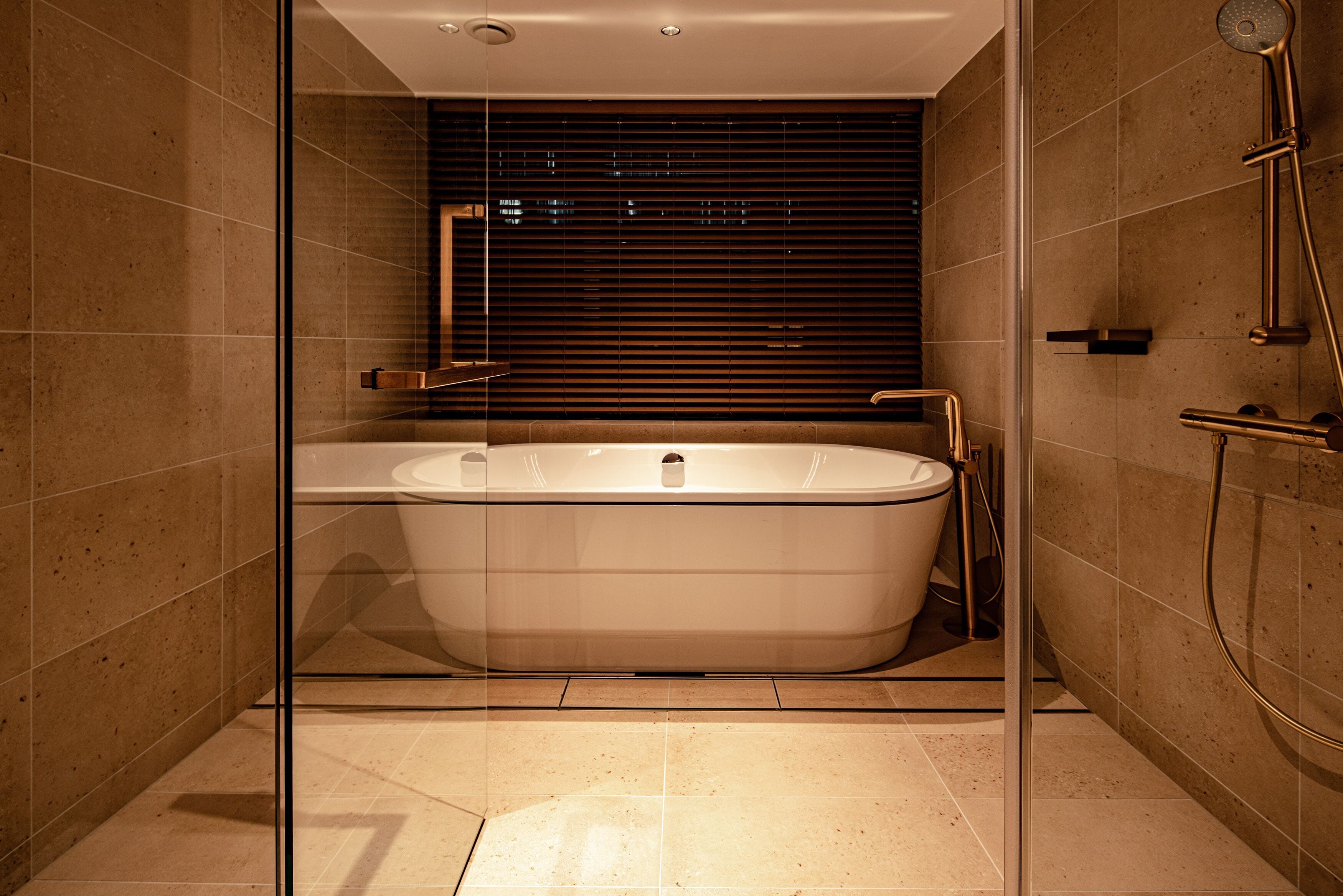 A modern bathroom with a freestanding bathtub, a glass shower enclosure, and a large mirror.