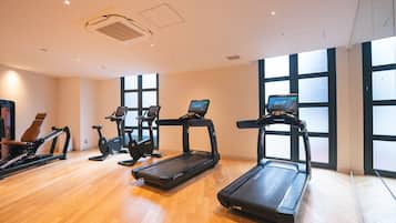 A gym with treadmills, elliptical machines, and a rowing machine.