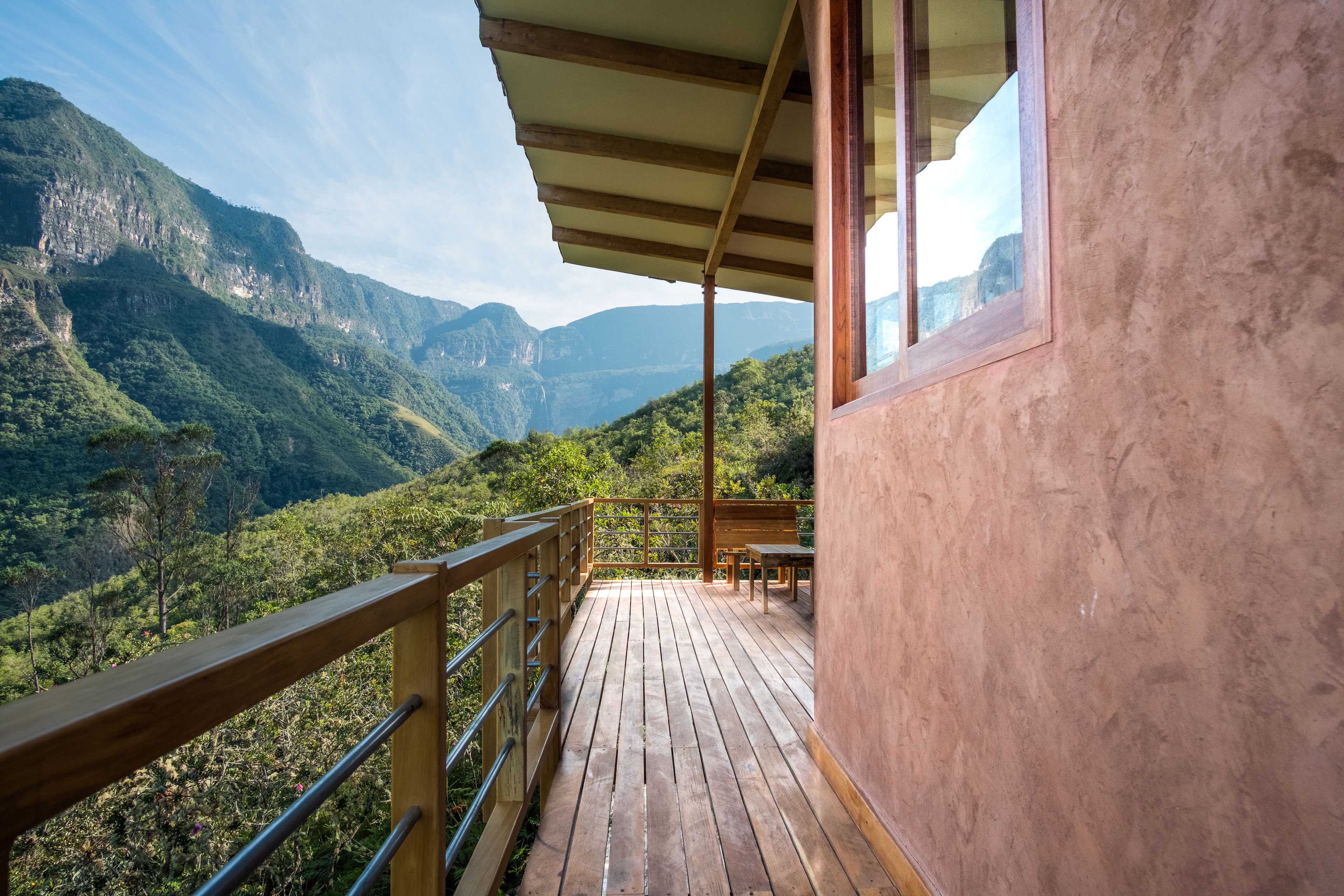 A wooden deck with a view of a mountainous landscape.