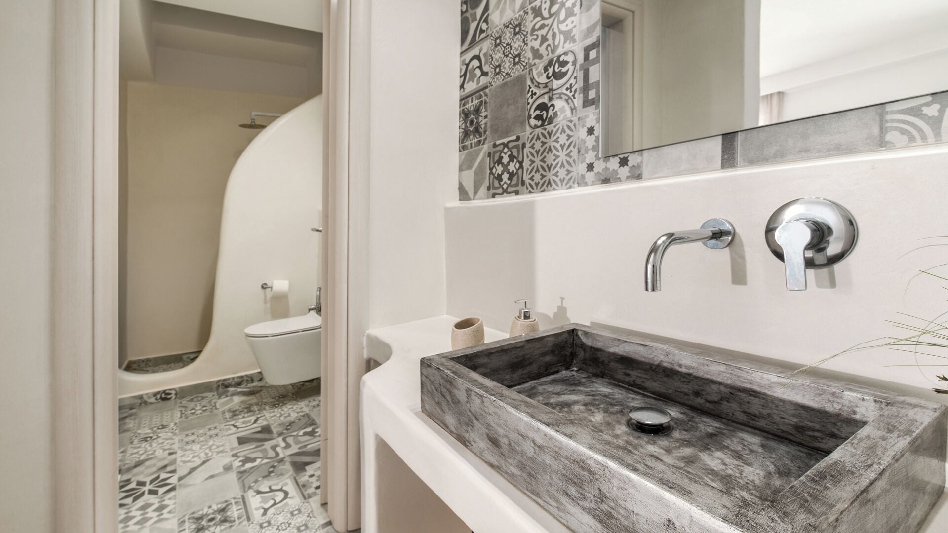 Un baño con un lavamanos grande rectangular, un inodoro y una ducha.