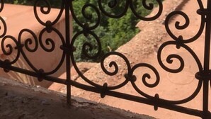 A wrought iron gate with a view of a mountainous landscape and greenery. - Kasbah Des Montagnes (Ighil N'Oumgoun)