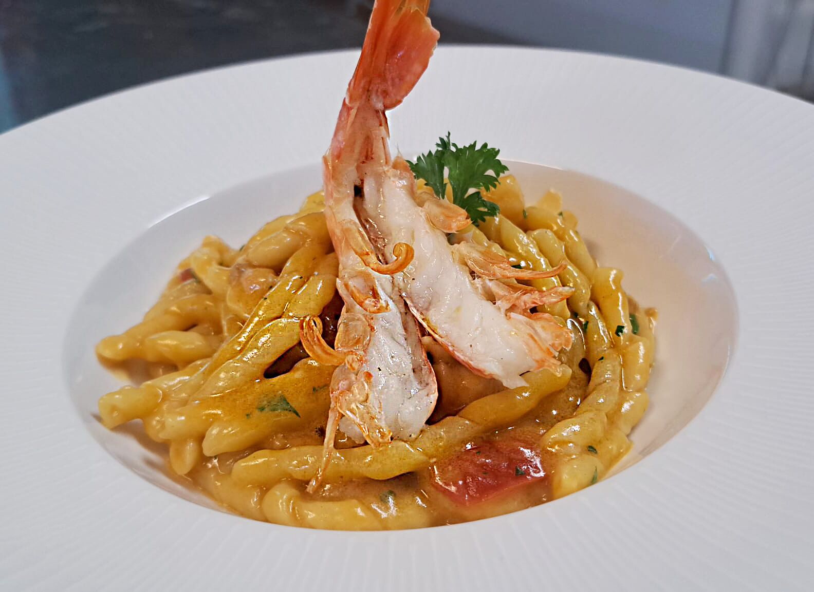Eine Pasta-Zubereitung mit Garnelen und Garnitur.