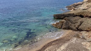 A coastal landscape with clear blue waters, rocky shorelines, and distant hills. - Villetta dello Scrittore (Capoliveri)