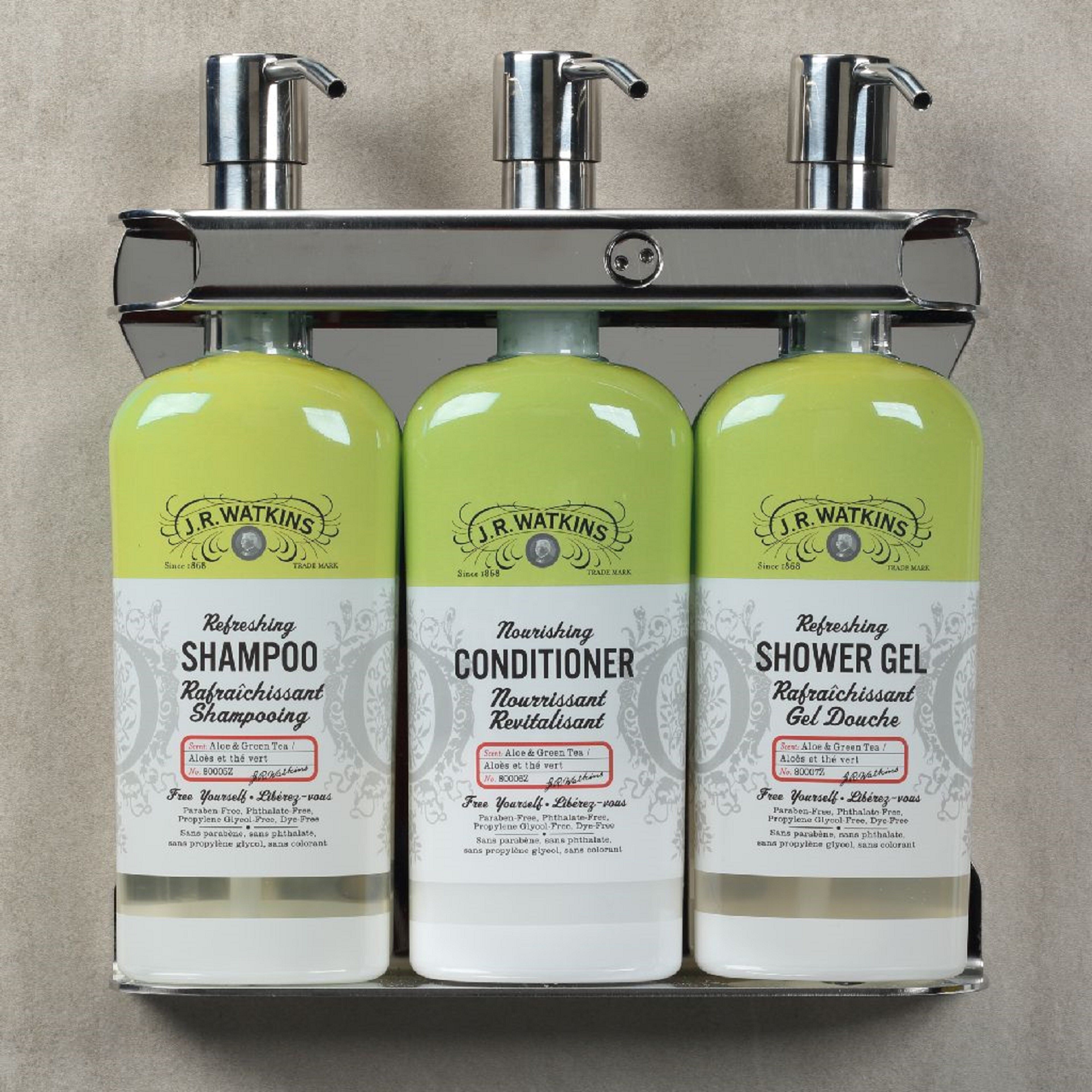 Three bottles of J.R. Watkins products: shampoo, conditioner, and shower gel, each with a green label and a white base.
