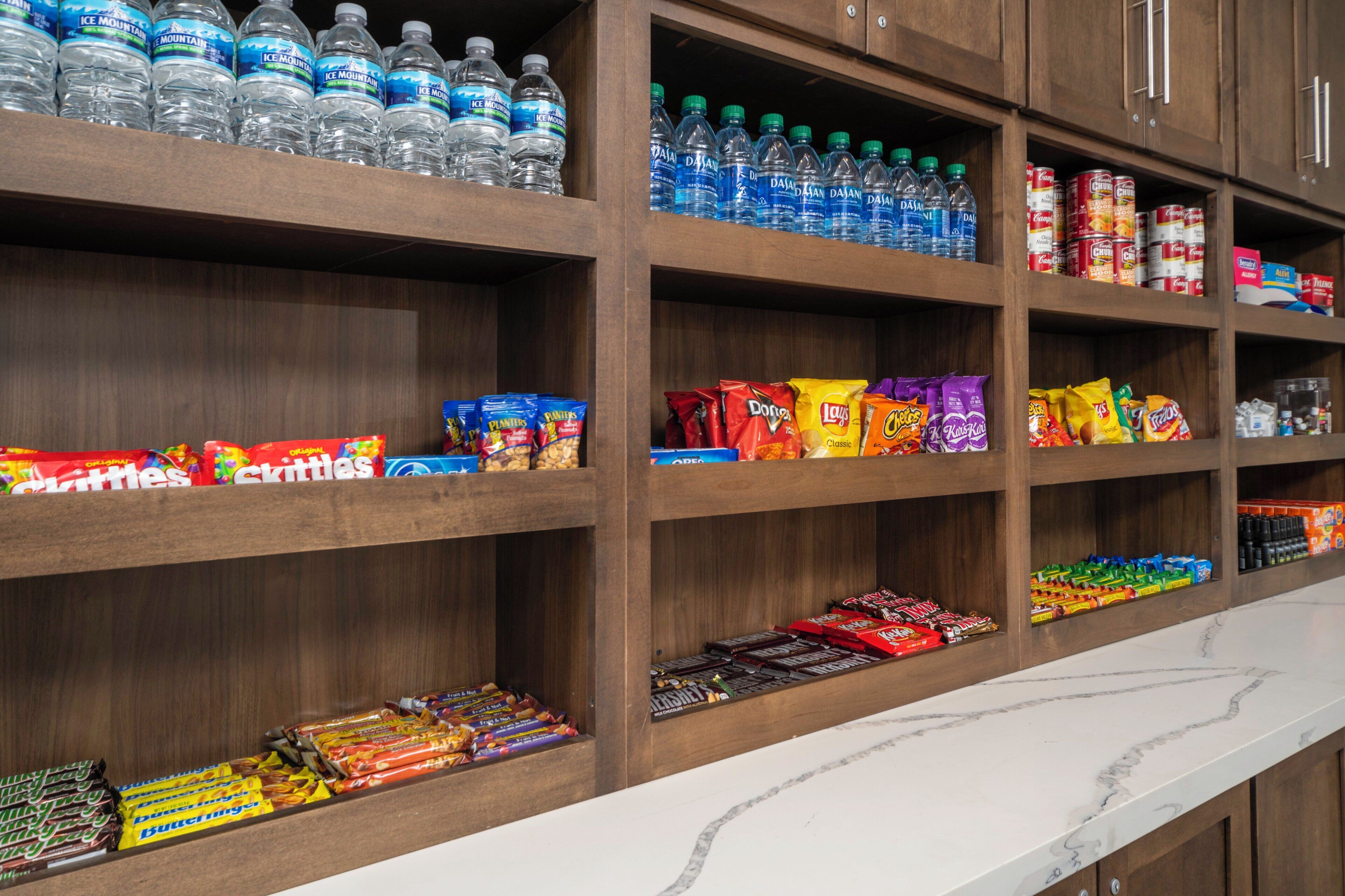 A snack and beverage shelf with various products.