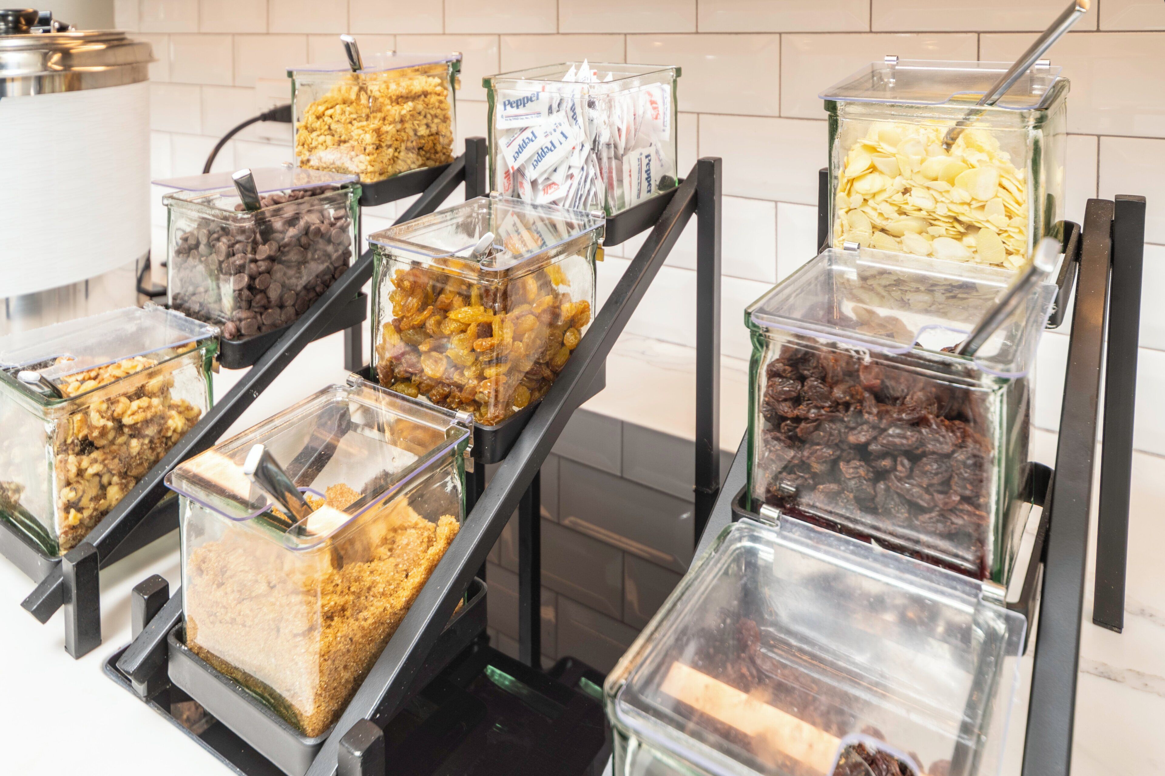 A buffet with various food items in clear containers.