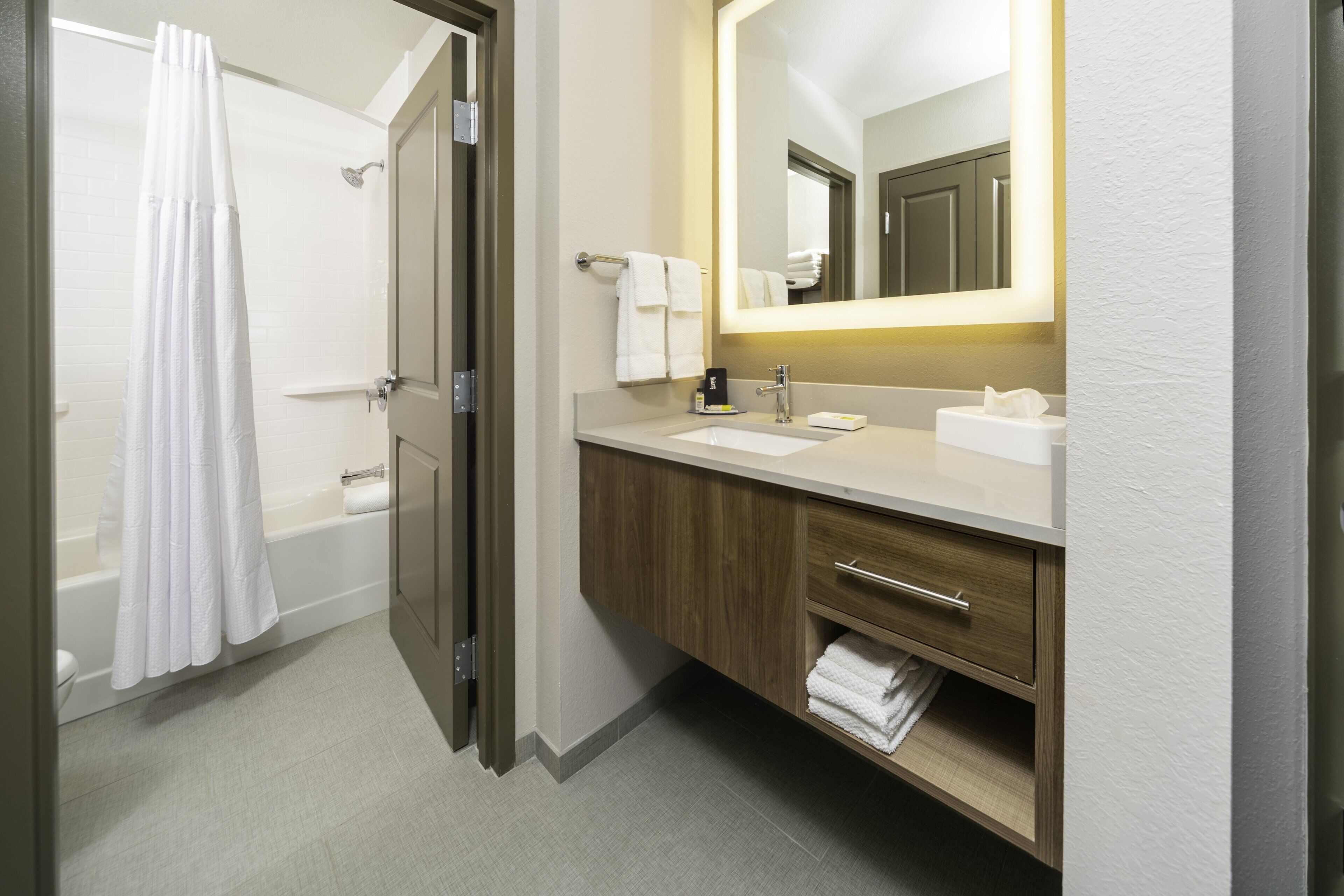 designer toiletries, hair dryer, towels, soap