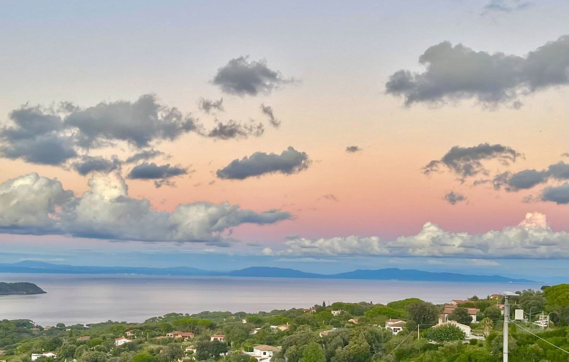 A coastal landscape with houses and a body of water.