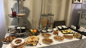 A buffet table with various food items including pastries, fruits, and condiments. - Chemin des Dames Le Relais De Fleurette (Pontavert)
