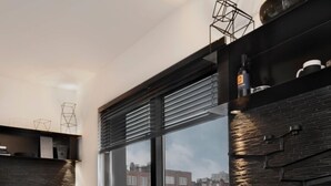 A modern living room with a large window, a sofa, a coffee table, and a bar stool.