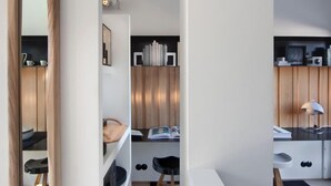 A modern kitchen with white cabinetry, wooden accents, and a central island.