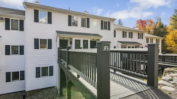 A multi-story residential building with a wooden deck and a sign indicating units 30-31.