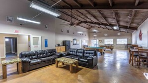 A spacious indoor area with a pool table, leather sofas, and a billiards table. - Elite Cabins and RV Park (Big Spring)