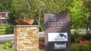 A sign for Topnotch Resort with logos for The Roost and Fannel. - Brookside 2 BR at Topnotch (Stowe)
