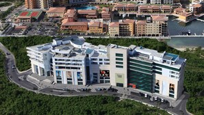 A modern building with multiple floors, large windows, and a prominent entrance. - Blue Residences at Blue Mall (Lowlands)