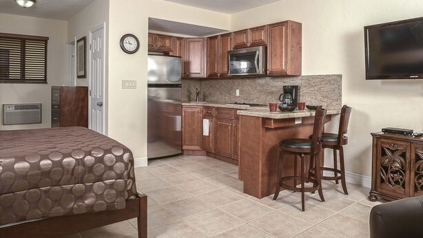 A compact kitchen with a refrigerator, microwave, and coffee maker. - Shell Studios Hallandale Beach (Hallandale Beach)