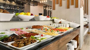A buffet with various food items including fruits, meats, and salads. - Ramada by Wyndham Van (Edremit)