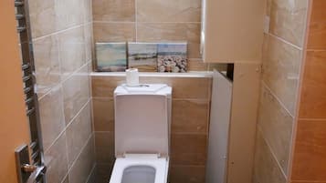 Separate bathtub and shower, deep-soaking bathtub, designer toiletries