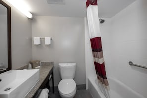 A bathroom with a white sink, toilet, and bathtub. - Red Roof Inn PLUS+ Tuscaloosa - University (Tuscaloosa)