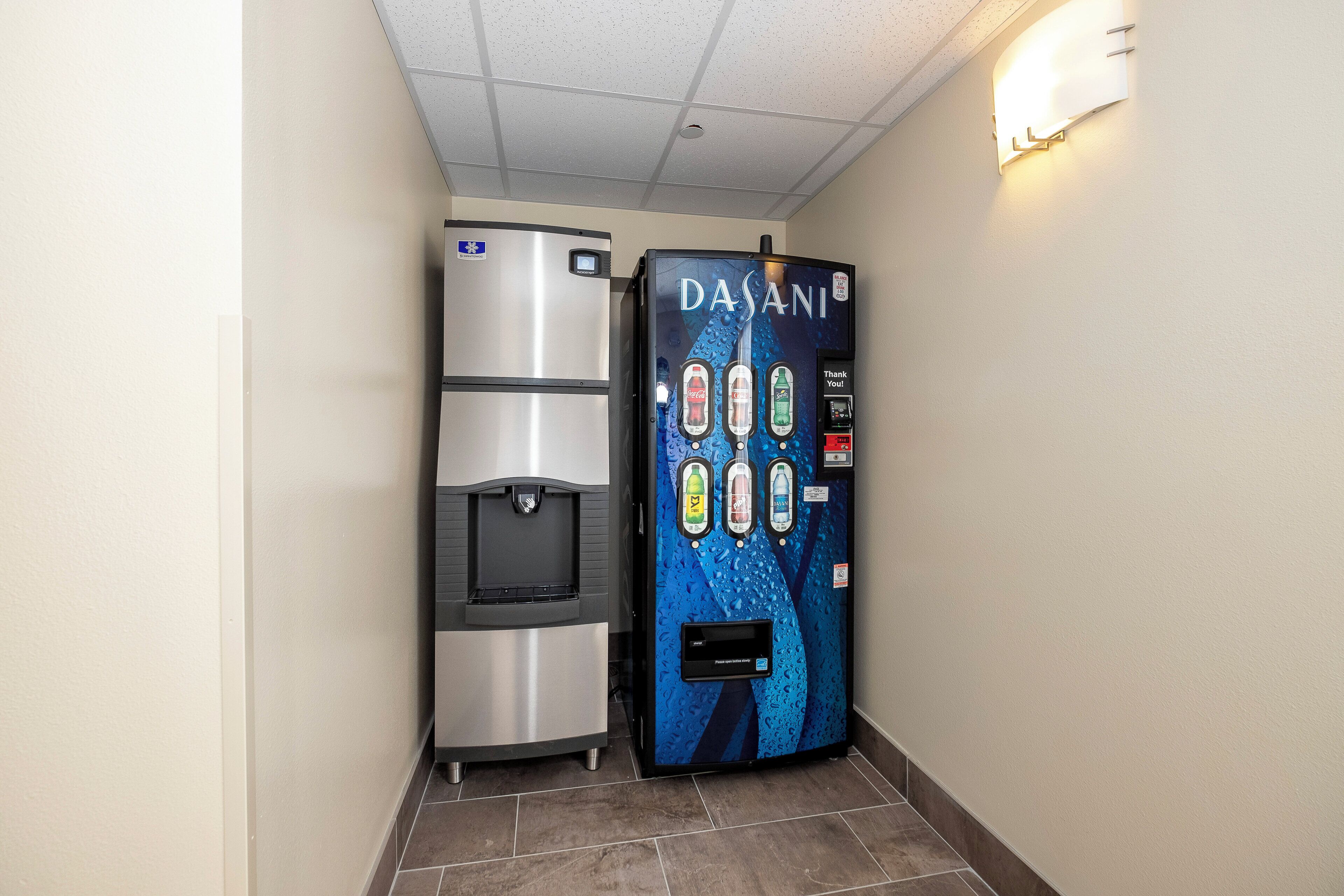 Un distributeur d’eau et un distributeur automatique de boissons se trouvent dans un couloir.