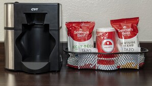 A coffee maker and bags of Seattle's Best coffee on a table. - Red Roof Inn PLUS+ Tuscaloosa - University (Tuscaloosa)