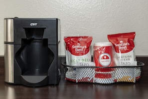 A coffee maker and bags of Seattle's Best coffee on a table. - Red Roof Inn PLUS+ Tuscaloosa - University (Tuscaloosa)