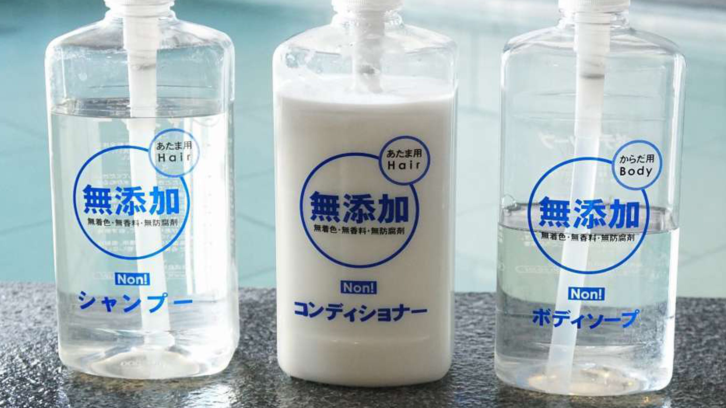 Three bottles of hair and body care products with labels indicating they are non-coloring, fragrance-free, and non-irritating.