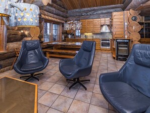 A log cabin interior with a kitchen, dining area, and seating. - Kitka-nokkela by Interhome (Kuusamo)