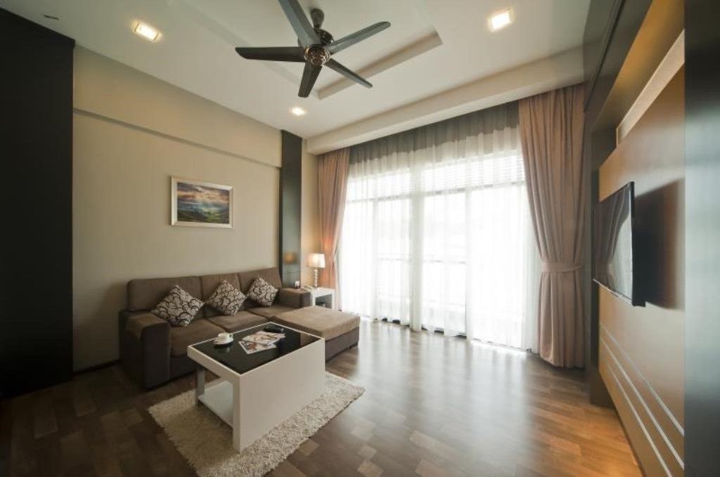 A modern living room with a sofa, coffee table, and a ceiling fan.