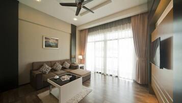A modern living room with a sofa, coffee table, and a ceiling fan.