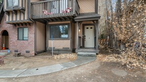 A two-story building with a balcony, a door, and a window. - Bear Retreat - Walk to Snow Summit, Hot Tub, Fireplace (Big Bear Lake)