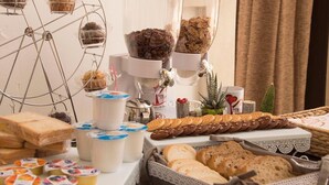 A buffet setup with various food items, including pastries, bread, and dairy products. - La Dimora di Marco (Melendugno)