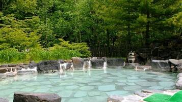 Surrounded by lush greenery, this natural hot spring offers a serene escape.