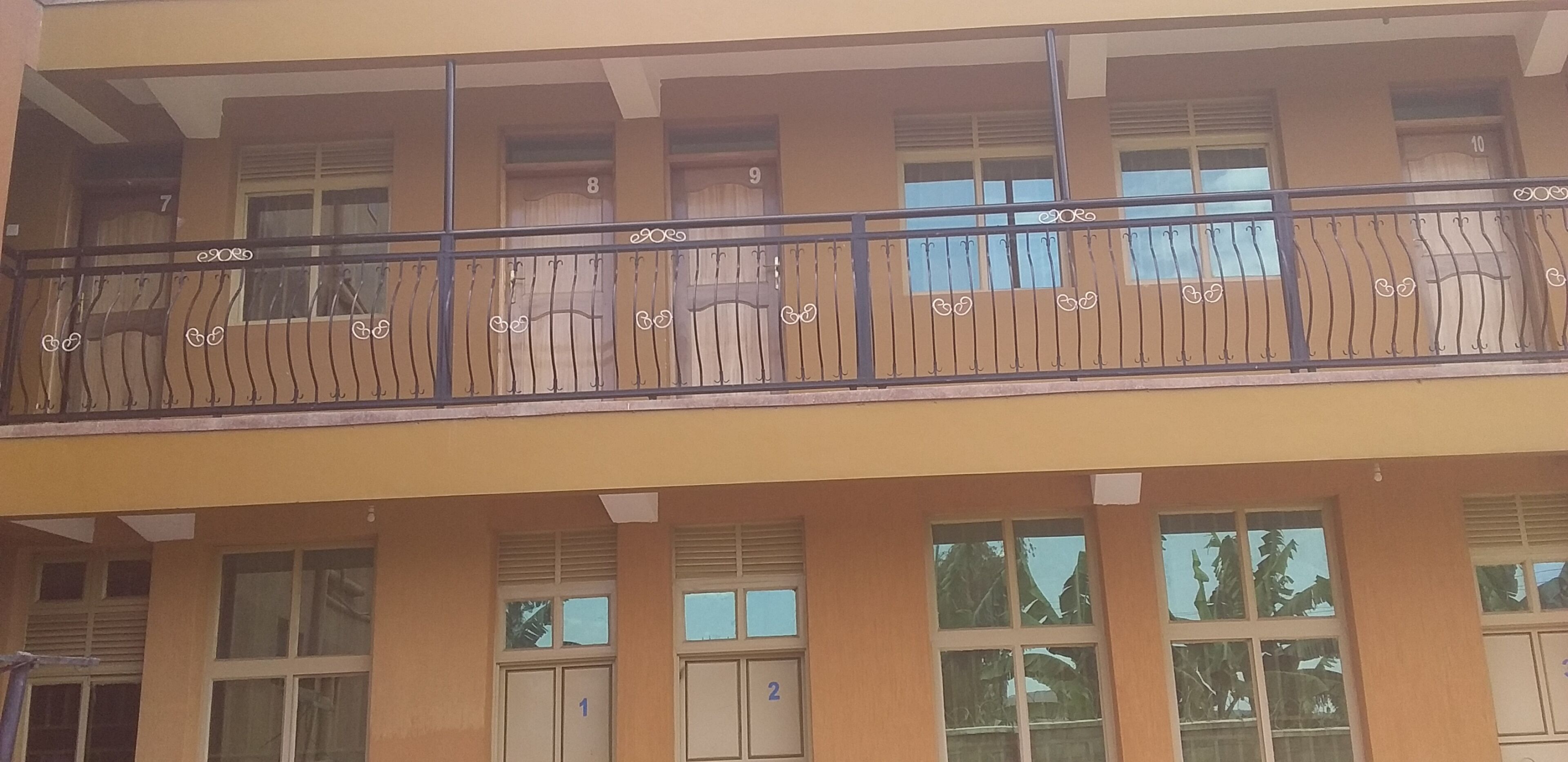 A multi-story building with numbered windows and balconies.