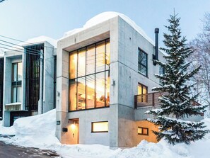 A modern building with large windows and a snow-covered exterior. - Kita Kitsune Chalet (Kutchan)