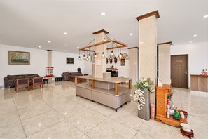 A hotel lobby with a reception desk, seating area, and a door labeled 'OFFICE'. - Romeo Juliet Dalat Resort (Da Lat)