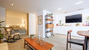 Deluxe Apartment | Living area | 120-cm flat-screen TV with digital channels, TV