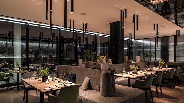 A modern restaurant with high tables, cushioned seating, and pendant lighting. - Das Altmühltal (Eichstaett)