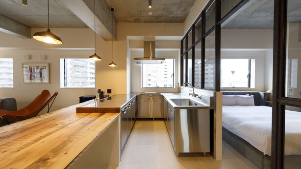 A modern kitchen with a wooden countertop, stainless steel appliances, and a built-in oven. - Hotel Mei Fukuoka Tenjin (Fukuoka)