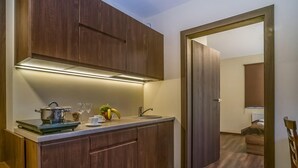 A modern kitchen with wooden cabinets, a countertop, and a built-in oven.