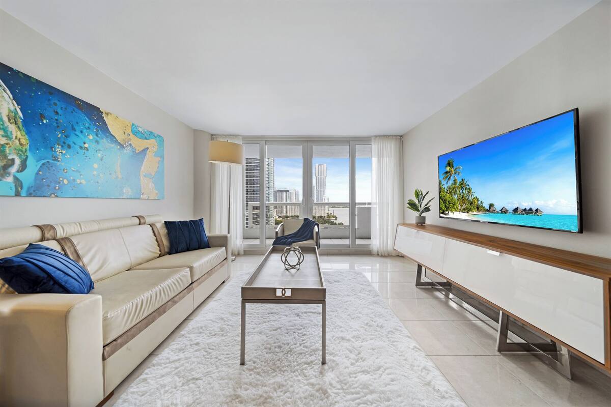 A modern living room with a sofa, coffee table, and TV.
