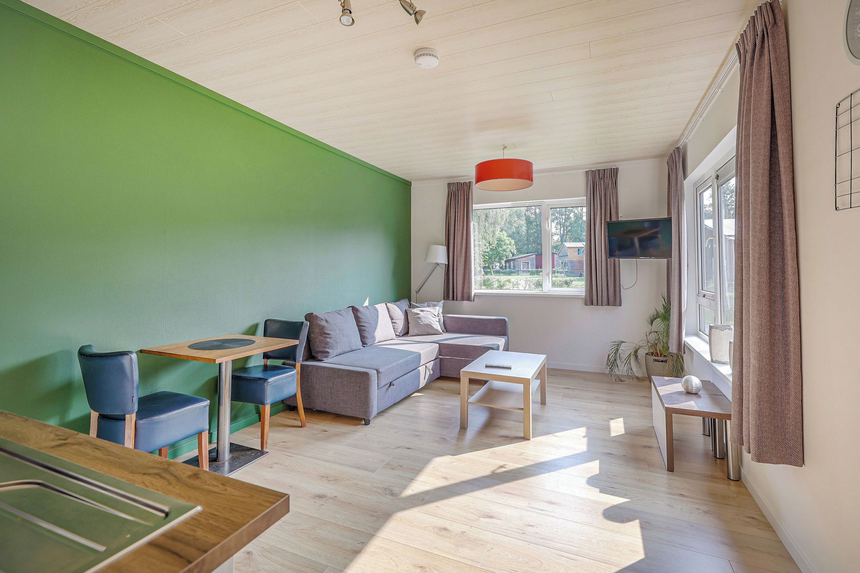 Deluxe Cabin, 1 Bedroom, Terrace, Garden Area | Living room | 32-inch Smart TV with cable channels, TV, Netflix